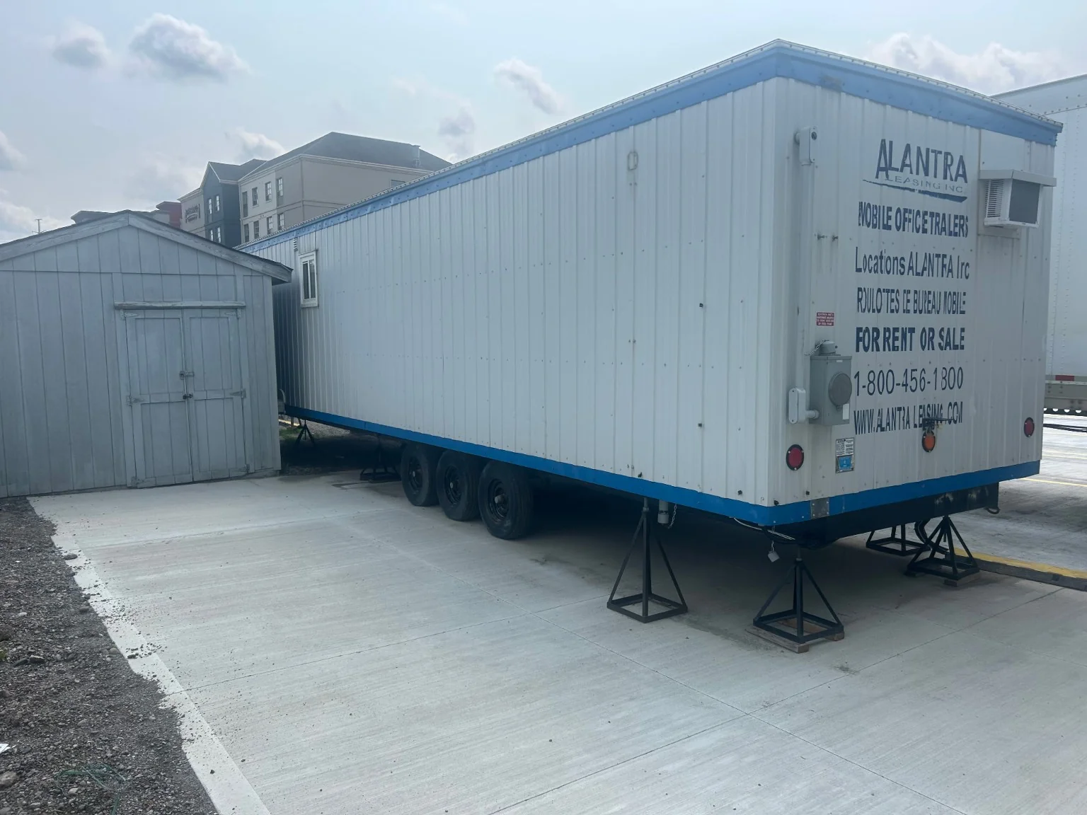 Finished concrete bearing area beneath a supported mobile trailer